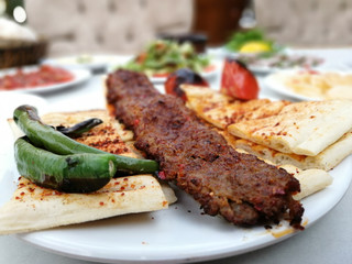 delicious Adana kebab and salads