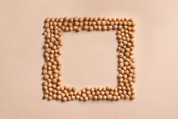 Square chickpeas seeds frame, border of chick pea beans, grain. Recipe background, copy space for text, top view. Food source of plant based vegan protein. Healthy vegetarian diet, veggie superfood. 