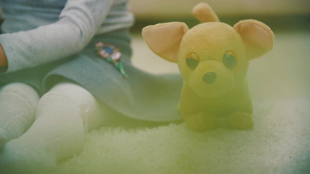 4k slowmotion video of girl on the floor playing.