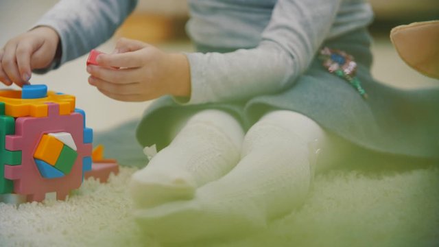 4k slowmotion video of girl on the floor playing.