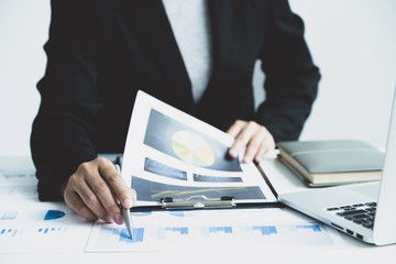 Businesswoman analysis the chart with laptop at the office for setting challenging business goals And planning to achieve the new target