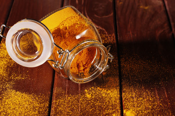 glass of turmeric on the wooden background