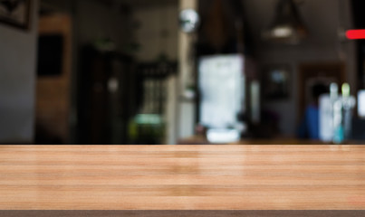 Empty wooden table with blurred cafe and coffee shop interior background
