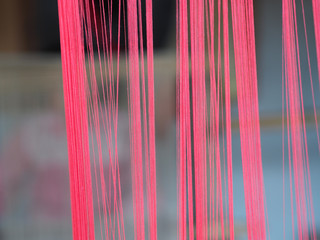 Closeup shot of pink threads on a blurred background