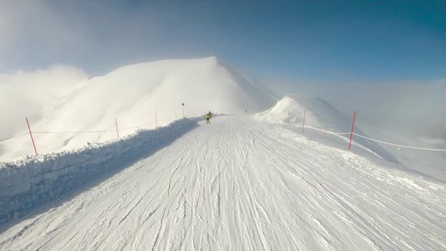 Flat track in a ski resort on a sunny foggy day spanish Pyrenees. Boy skiing pushing sticks.