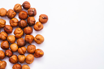 Whole hazelnut kernels lie on a white background. The autumn harvest.