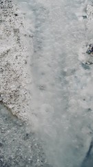 Abstract White and Light Blue Natural Spring with Dark Gray Rocks