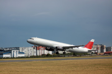 Passenger plane takes off from the airport runway. Side-view of aircraft