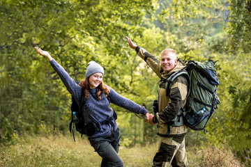 A young beautiful girl and her young man are walking in the Park, enjoying their freedom.