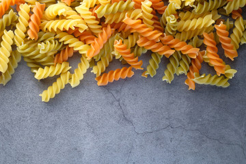 Variety of types and shapes of dry Italian pasta on black background 