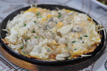 Oyster omelette or stir fried Oyster with egg and vegetable, shell omelet