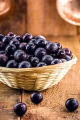 Jaboticaba or jabuticaba, Brazilian and South American fruit, in a rustic wooden basket. Fruit used in sweets, jellies, drinks and medicinal use.