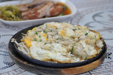 Oyster omelette or stir fried Oyster with egg and vegetable, shell omelet