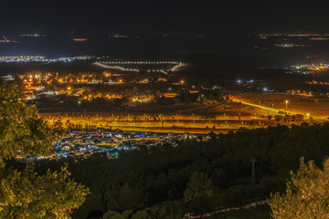 Aerail night view of Hula Valley with town of Rosh Pina and many agricultural settlements as seen from Mitzpe Hayamim hotel, located in Upper Galilee of Northern Israel, Israel.