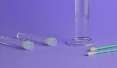 The medical swab, behind part of a specimen and next to it, two test tubes, space for text