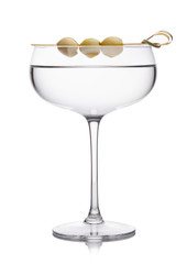 Vodka martini gin cocktail in luxury crystal glass with olives on bamboo stick on white background with reflection.
