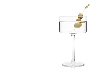 Vodka martini gin cocktail in modern glass with olives on bamboo stick on white background with reflection.