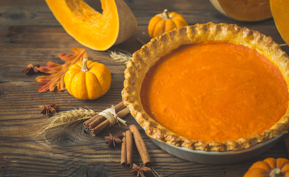 Fresh homemade pumpkin pie on the wooden table