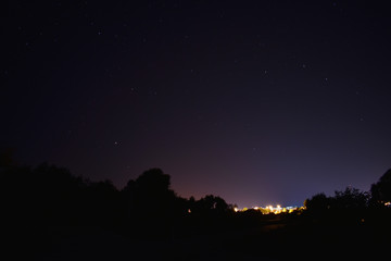 Village at night with stars