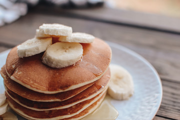 Delicious pancakes topped with banana and honey. Homemade classic american pancakes. Breakfast in the morning. 