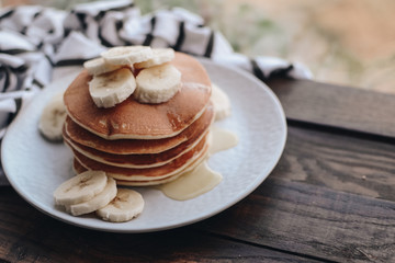Delicious pancakes topped with banana and honey. Homemade classic american pancakes. Breakfast in the morning. 