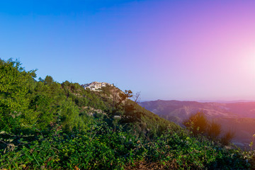 Fototapeta na wymiar Panoramic View of the small village of Castroregio, in Basilicata, Italy. Summer Sunrise of scenic landscape of a small village in the South of Italy