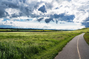 A summer storm forms over a section of the Trans Canada Trail at Glenbow Provincial Park Alberta.