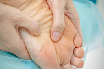 Foot foot massage hands in the Spa close up