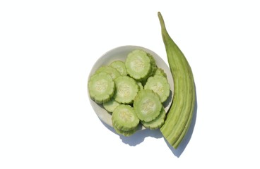 Armenian Cucumber or Yard Long Cucumber in a Plate Isolated on White Background with Copy Space, Also Known as Kakri