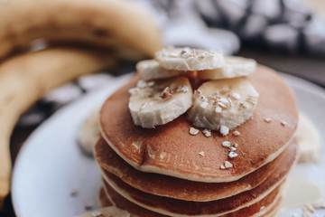 Delicious pancakes topped with banana and honey. Homemade classic american pancakes. Breakfast in the morning. 