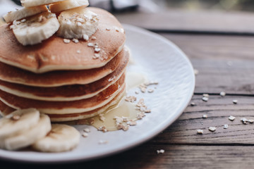 Delicious pancakes topped with banana and honey. Homemade classic american pancakes. Breakfast in the morning. 