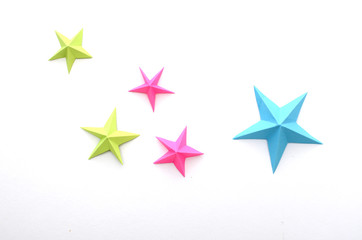 Obraz premium Colorful holiday origami stars on white