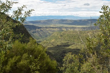 Obraz premium Scenic view of a volcanic crater against mountains at Mount Suswa, Kenya