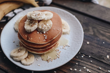 Delicious pancakes topped with banana and honey. Homemade classic american pancakes. Breakfast in the morning. 