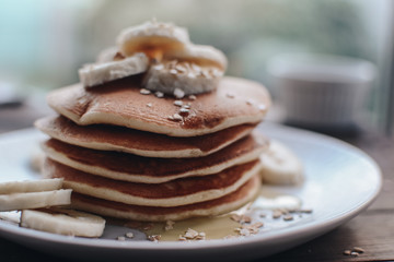 Delicious pancakes topped with banana and honey. Homemade classic american pancakes. Breakfast in the morning. 
