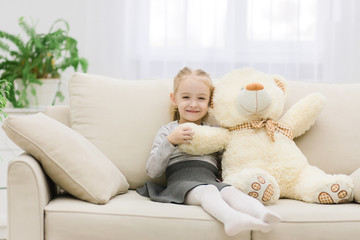 Cute little girl portrait in studio with teddy-bear.