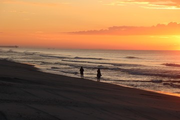 silhouette of a people walking on the beach