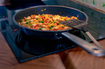 close up of frying pan cooking chicken chorizo at home kitchen.