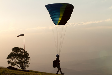 paraglider alone in mountain top at sunset, Brazil. Adventure concept