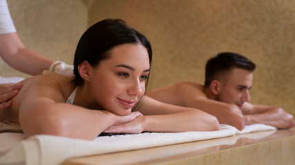 Obraz na płótnie Canvas a girl and a guy in a spa on a massage