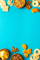 Snacks mix frame top view. Nuts and dried fruits with crackers, copy space