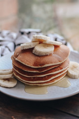 Delicious pancakes topped with banana and honey. Homemade classic american pancakes. Breakfast in the morning. 