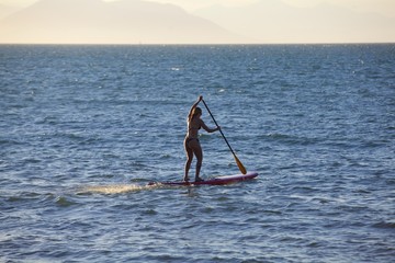 Fototapeta na wymiar woman paddle board in Rio de Janeiro at sunset