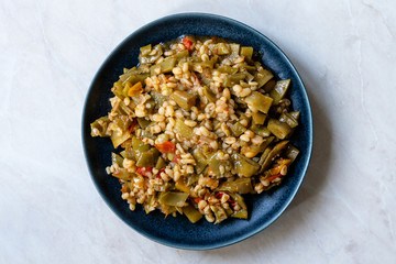 Turkish Olive Oil Food Green Peas / Fasulye Diblesi or Ayse Kadin Dible with Bulgur / Bulghur Rice served in Plate