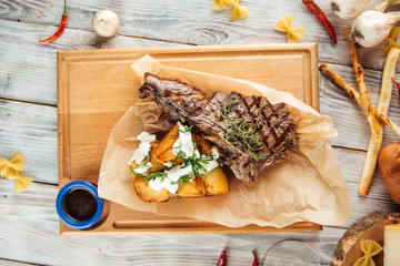 T bone steak with potatoes in sour cream