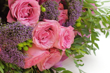 Pretty bouquet with pink roses and other small flowers, color tender roses and purple flowers 