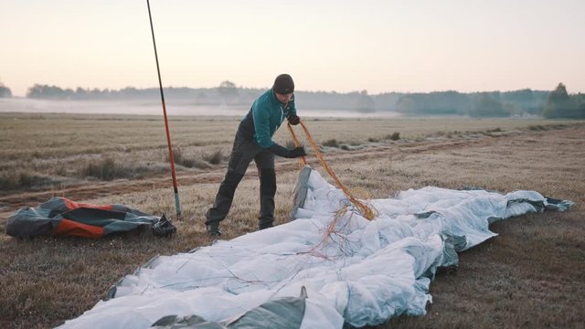 Paramotorgliding. Successfully landed, glider untying parachutist. High quality 4k footage