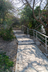 A new stone staircase of 800 steps to Jasper Beach, built in the spring of 2020. The reserve on the Black Sea. Cape Fiolent, Crimea Peninsula. Bright sunny spring day, calm crystal clear blue sea. The