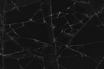 Black cracked glass texture background. Crack on the glass. Broken screen. Broken dark phone.  White cracks in glass