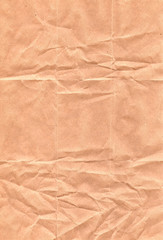 Vertical texture of crumpled brown paper. Substrate for poster.